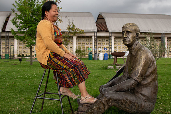 Miriam Pixtun, Historikerin aus Guatemala, sitzt vor der Skulptur des Schuhputzers Heriberto de la Calle. Er war eine Kultfigur, die satirische Radiointerviews mit Prominenten führte und der Gesellschaft den Spiegel vorhielt. Geschaffen hatte ihn der Journalist, Komiker und Friedensaktivist Jaime Garzón, der am 13. 08. 1999 ermordet wurde.